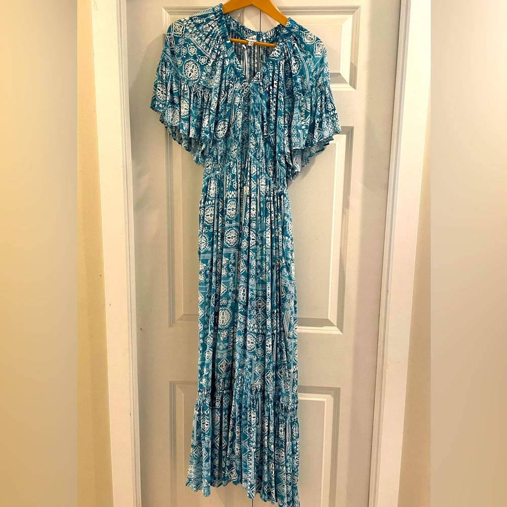 Beautiful turquoise print dress w/ graceful wing sleeves. Brand new, tags on.
